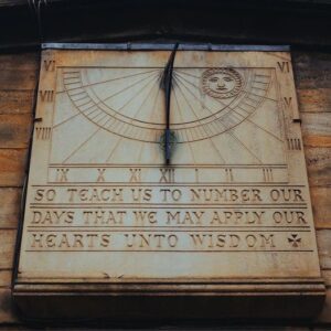 A sun dial with the words " so teach us to number our days that we may apply our hearts unto wisdom ".